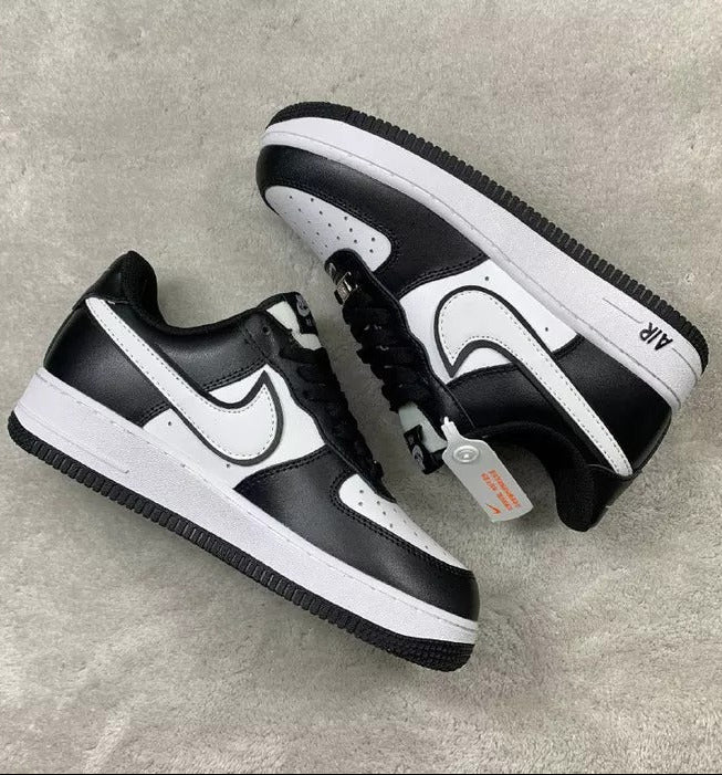 Black and white sneakers on a gray surface