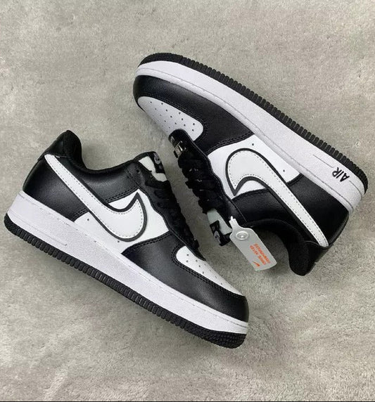 Black and white sneakers on a gray surface
