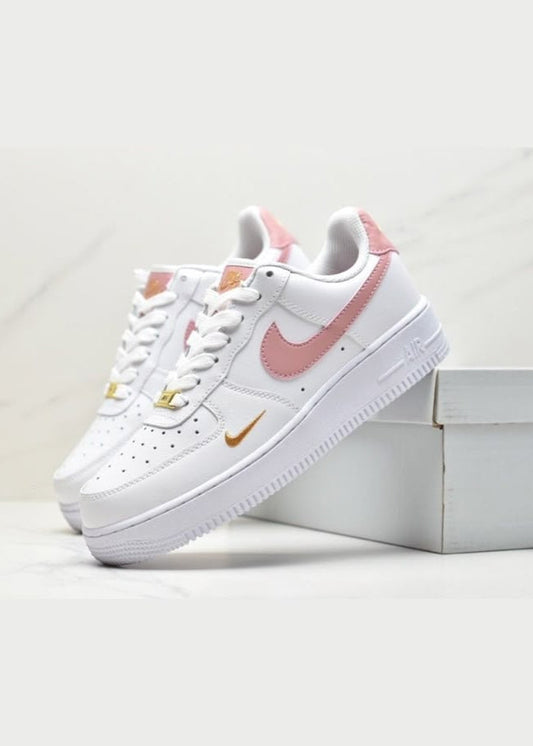 White sneakers with pink accents on a white background